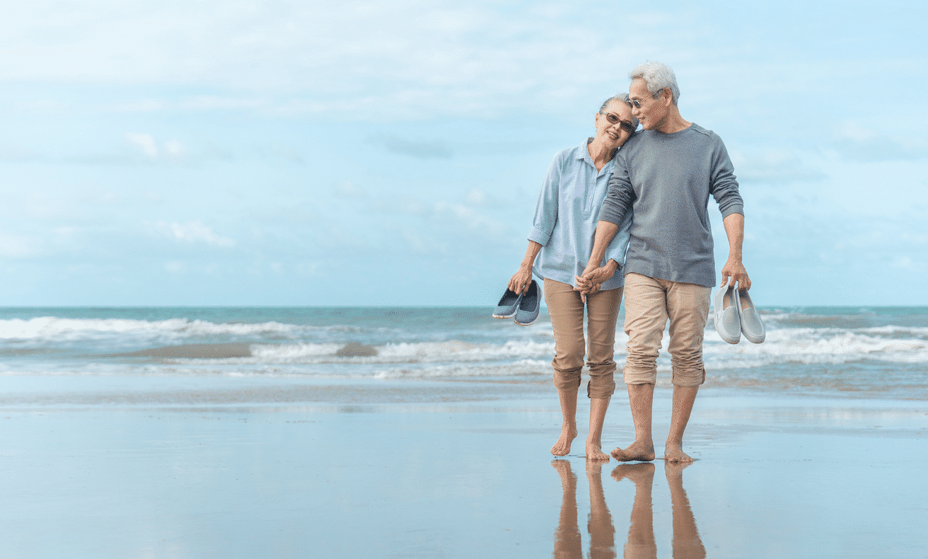 Older-couple-walking-on-beach_2.png__PID:194acce7-3bc7-4dda-b075-6160375804f2